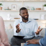 Male therapist meets with couple