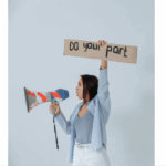 woman holding sign that says do your part