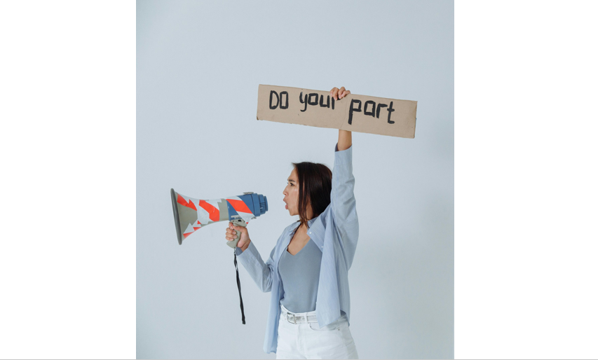 woman holding sign that says do your part